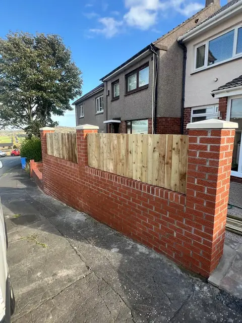 Wall and fencing complete along the front