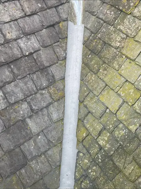 Lead flashing running down between the slates